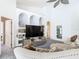Gathering room with built-in shelving, large TV, and comfy seating at 139 Belfry Dr, Davenport, FL 33897