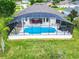 Aerial view of house with a large screened pool at 139 Belfry Dr, Davenport, FL 33897