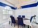 Elegant dining room with a chandelier, blue walls, and a large table at 139 Belfry Dr, Davenport, FL 33897