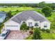 Single-story home with a large yard, driveway, and golf course view at 139 Belfry Dr, Davenport, FL 33897