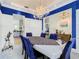 Formal dining room features a chandelier and view into the kitchen at 139 Belfry Dr, Davenport, FL 33897