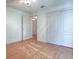 Bright bedroom with wood floors and double door closet at 1302 Oporto Dr, The Villages, FL 32162