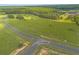 Aerial view of a large lot with wooded area and road access at 38530 Wooded Meadow Drive, Umatilla, FL 32784
