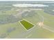 Aerial view highlighting a lot near a lake and other properties at 38530 Wooded Meadow Drive, Umatilla, FL 32784