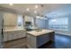 Modern kitchen with a large island, stainless steel appliances, and white cabinets at 38530 Wooded Meadow Drive, Umatilla, FL 32784