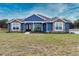 New construction home features stone accents and a welcoming front porch at 38530 Wooded Meadow Drive, Umatilla, FL 32784