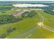Aerial view of property highlighting a spacious lot near a lake at 38530 Wooded Meadow Drive, Umatilla, FL 32784