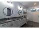 Elegant bathroom with double sinks, frameless shower, and modern fixtures at 38530 Wooded Meadow Drive, Umatilla, FL 32784