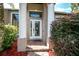 Welcoming front entry with columns and a glass door at 27637 Lisa Dr, Tavares, FL 32778