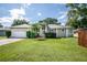 Single-story home with a two-car garage and well-maintained lawn at 27637 Lisa Dr, Tavares, FL 32778