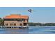 Lakefront home with attached boathouse and seaplane overhead at 27637 Lisa Dr, Tavares, FL 32778