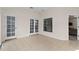Bright sunroom with tile floors, French doors, and view into the living area at 27637 Lisa Dr, Tavares, FL 32778