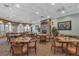 Casual dining area with stone fireplace and numerous tables at 26923 Camerons Run, Leesburg, FL 34748