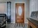 Front entry with wood door, patterned rug and gray walls at 4988 County Road 155, Wildwood, FL 34785