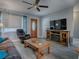 Cozy living room featuring a fireplace, comfy seating, and large TV at 4988 County Road 155, Wildwood, FL 34785