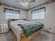 Relaxing bedroom with a king-size bed and two windows for natural light at 4988 County Road 155, Wildwood, FL 34785
