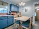 Kitchen with blue cabinets, breakfast nook, and view to hallway at 4988 County Road 155, Wildwood, FL 34785