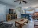 Open living space with kitchen and a built-in fireplace at 4988 County Road 155, Wildwood, FL 34785
