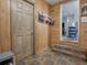 Entryway with wood walls, tiled floors, and built-in storage at 4988 County Road 155, Wildwood, FL 34785