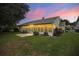 Back of house with screened porch and small yard at 4907 Tara View Rd, Leesburg, FL 34748