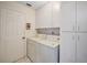 Laundry room with washer, dryer, and storage cabinets at 4907 Tara View Rd, Leesburg, FL 34748