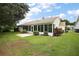 Back of house with screened porch and small yard at 4907 Tara View Rd, Leesburg, FL 34748