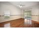 Bedroom with hardwood floors, sliding doors to patio, and ceiling fan at 4907 Tara View Rd, Leesburg, FL 34748