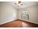 Bright bedroom featuring hardwood floors and a ceiling fan at 4907 Tara View Rd, Leesburg, FL 34748