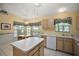 Kitchen features an island, wood cabinets, and a breakfast nook at 4907 Tara View Rd, Leesburg, FL 34748