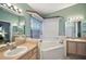 Bathroom with double vanity, corner tub, and separate shower at 4907 Tara View Rd, Leesburg, FL 34748