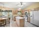 Kitchen with island, wood cabinets, and stainless steel appliances at 4907 Tara View Rd, Leesburg, FL 34748