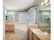 Bathroom with double vanity, corner tub, and tile flooring at 4907 Tara View Rd, Leesburg, FL 34748