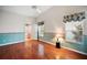 Primary bedroom with wood floors and access to bathroom at 4907 Tara View Rd, Leesburg, FL 34748
