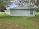 House's backyard with grassy lawn and partial fence at 36641 Tropical Wind Ln, Grand Island, FL 32735