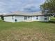 Spacious backyard with grassy lawn and partial view of the house at 36641 Tropical Wind Ln, Grand Island, FL 32735