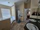 Main bathroom with double sinks, garden tub, and shower at 36641 Tropical Wind Ln, Grand Island, FL 32735
