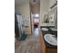 Bathroom with double sinks, shower, and linen storage at 36641 Tropical Wind Ln, Grand Island, FL 32735