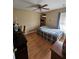 Bedroom with wood floors and ceiling fan at 36641 Tropical Wind Ln, Grand Island, FL 32735