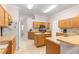 Kitchen with wood cabinets and island at 30549 Pga Dr, Sorrento, FL 32776