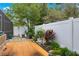 Landscaped backyard with wooden deck and privacy fence at 30549 Pga Dr, Sorrento, FL 32776