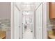 Laundry room with washer, dryer, and storage at 30549 Pga Dr, Sorrento, FL 32776