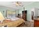 Main bedroom with a four-poster bed and access to the pool at 30549 Pga Dr, Sorrento, FL 32776