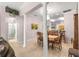 Bright dining room with columns, chandelier, and adjacent kitchen views at 30549 Pga Dr, Sorrento, FL 32776