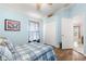 Light blue bedroom with ceiling fan and double door closet at 30549 Pga Dr, Sorrento, FL 32776