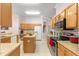 Kitchen features island, stainless steel appliances, and wood cabinets at 30549 Pga Dr, Sorrento, FL 32776