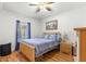 Bright bedroom with wood floors, double bed, and ceiling fan at 30549 Pga Dr, Sorrento, FL 32776