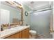 Bathroom with a shower, sink, and decorative mirror at 30549 Pga Dr, Sorrento, FL 32776