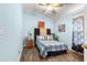 Bedroom with light blue walls, ceiling fan, and wood floors at 30549 Pga Dr, Sorrento, FL 32776