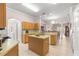 Spacious kitchen with island, ample cabinetry, and views into the dining area at 30549 Pga Dr, Sorrento, FL 32776