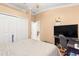 Bedroom with a large TV and home office at 30549 Pga Dr, Sorrento, FL 32776